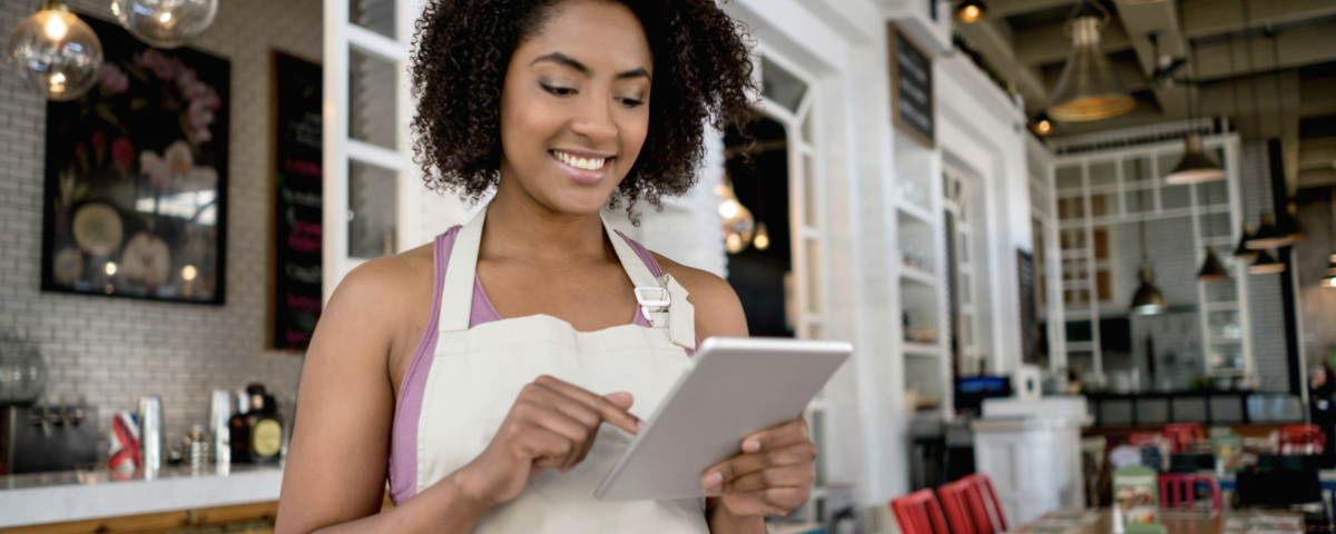 waitress in a restaurant using a digital tablet