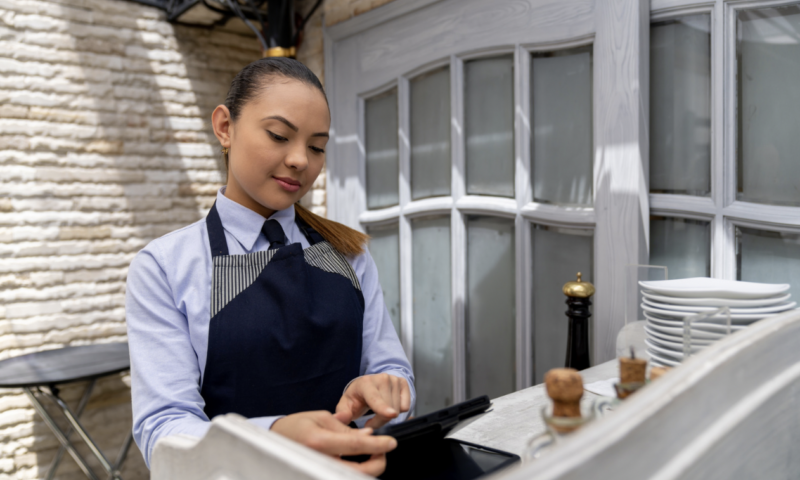 restaurant hostess putting in order on POS