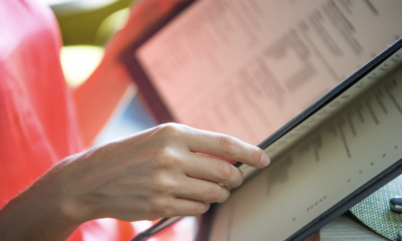 Woman reading restaurant menu