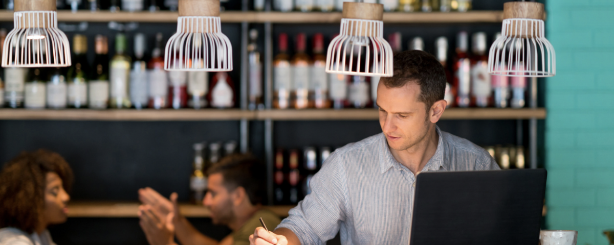 restaurant manager running reports at restaurant