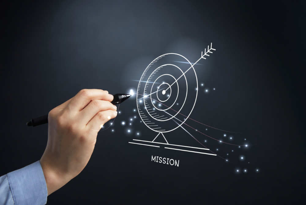 Mission Statement concept: man hand holding pen drawing target